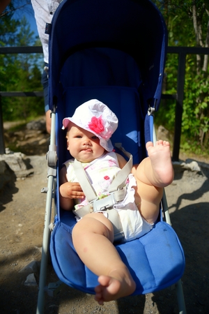 Baby in sitting stroller on natureの写真素材