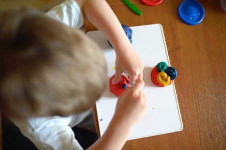 Little boy molds from plasticineの写真素材