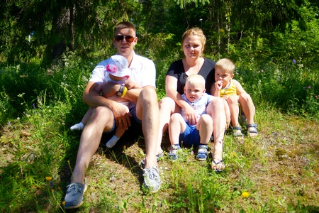 Happy family with three children outdoorsの写真素材