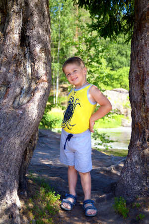Portrait of a cute boy posing near treeの写真素材