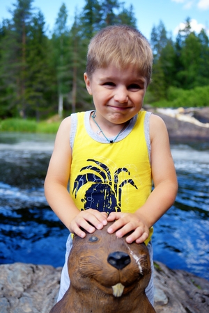 Portrait of a cute boy on edge of a riverの写真素材