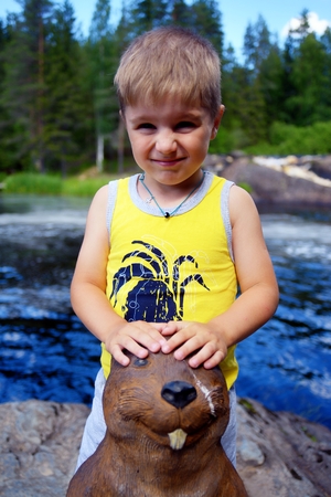 Portrait of a cute boy on edge of a riverの写真素材