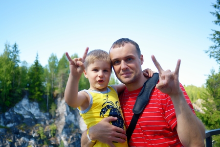 Father and son together show gesture v-signの写真素材