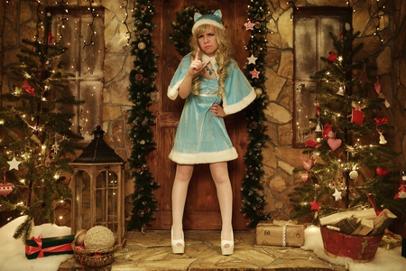 Snow Maiden on doorstep of house decorated in Christmas styleの写真素材