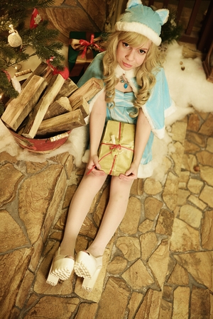 Snow Maiden on doorstep of house decorated in Christmas styleの写真素材