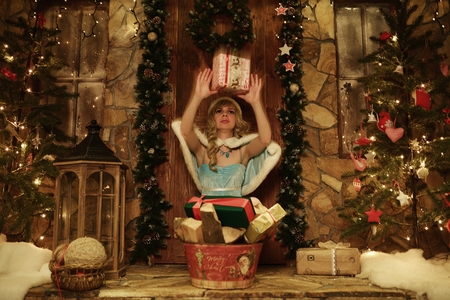 Snow Maiden throw present. Doorstep of house decorated in Christmas styleの写真素材