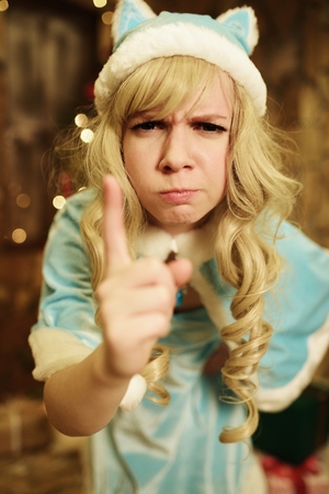 Snow Maiden on doorstep of house decorated in Christmas styleの写真素材