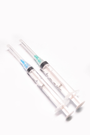 Two medical syringe closeup on white background isolatedの写真素材