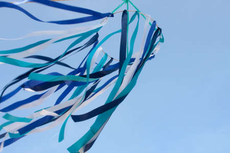 A blue, white and blue mobile ribbon in front of Patong Beach in Phuket, Thailand.の写真素材