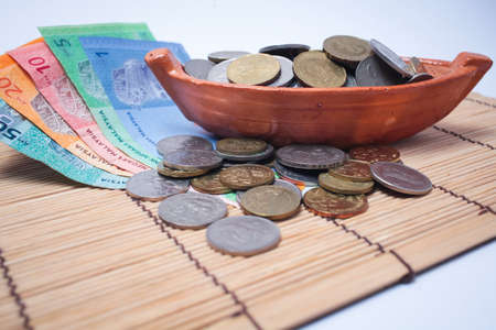 Malaysia Ringgit note and coins isolated on white background. Business and financial concept. Selective focus. Copy space.の写真素材