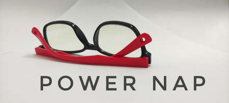 Eyeglasses on white background with power nap wording. Suitable for health and productivity concept.の写真素材
