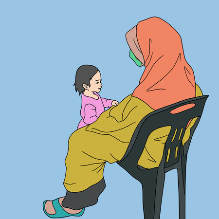 Muslim mother with her little daughter sitting on a chair.の写真素材