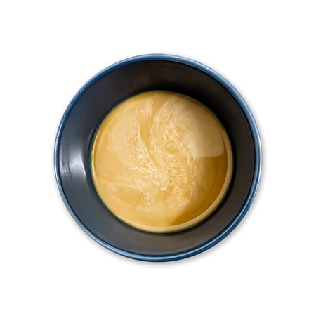 Bowl of condensed coffee milk isolated on white background. Top view.の写真素材