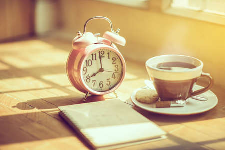 Coffee morning and alarm clock close up  in the morning sunlight,Good morning