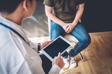 Doctors are consulting with young men about prostate cancer and venereal disease, including sexual dysfunction.Men Health Conceptの写真素材