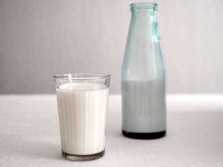 A bottle of milk, a faceted glass in an old retro style