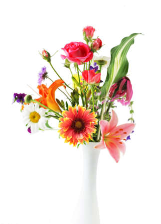 Elegant colorful flowers in the vase isolated on whiteの写真素材