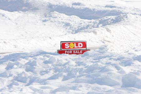 For Sale sign, sold, on snow groundの写真素材
