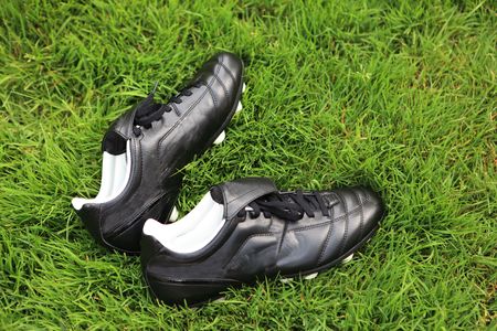 Pair of soccer shoes on grass fieldの写真素材