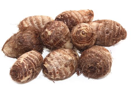 Group of taro root potatoes isolated on whiteの写真素材