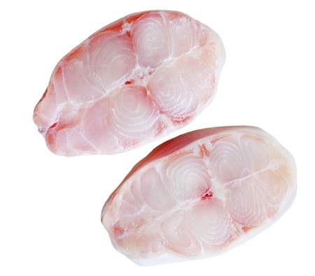 Two slices of raw catfish isolated over white
