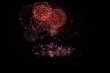 Colorful fireworks display over black background の写真素材