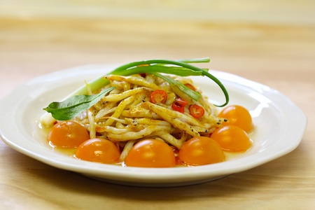 Dish of tiny silver fish with cherry tomatoes and green onion