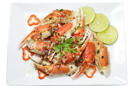Roasted garlic crab on plate isolated over whiteの写真素材