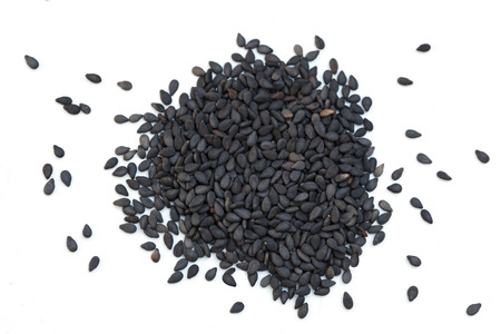 Pile of black sesame seeds isolated on white backgroundの写真素材