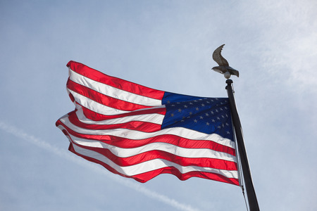 American flag flying in blue sky in the springtime