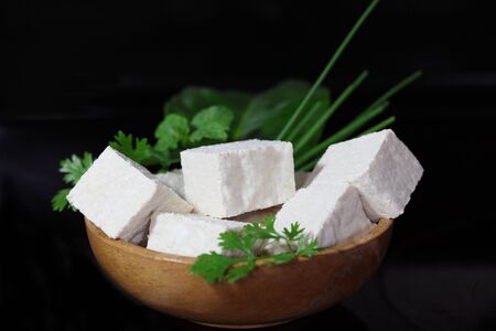 Wooden bowl with homemade tofu and homegrown vegetableの写真素材