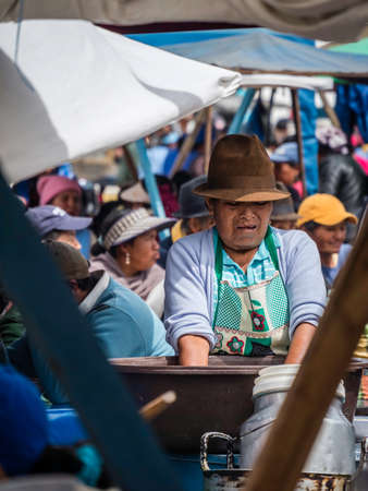 Saquisili, Ecuador - May 2, 2019 - indigenous lady selling in the Saquisili market in the Cotopaxi region of Ecuador, South Americaのeditorial素材