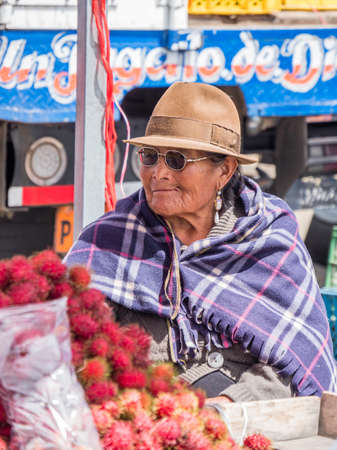 Saquisili, Ecuador - May 2, 2019 - indigenous lady selling in the Saquisili market in the Cotopaxi region of Ecuador, South Americaのeditorial素材