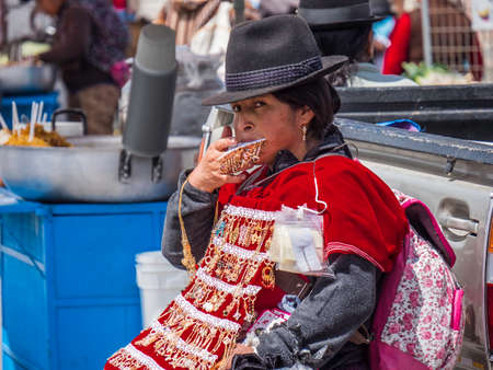Saquisili, Ecuador - May 2, 2019 - indigenous lady selling in the Saquisili market in the Cotopaxi region of Ecuador, South Americaのeditorial素材