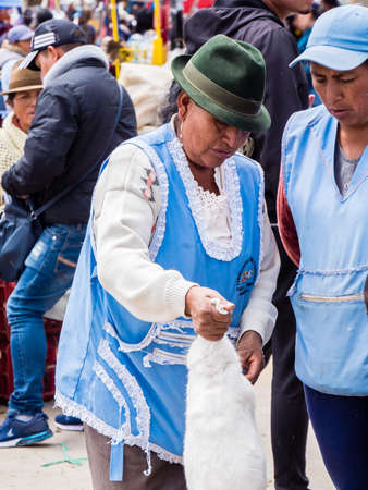 Saquisili, Ecuador - May 2, 2019 - indigenous lady selling in the Saquisili market in the Cotopaxi region of Ecuador, South Americaのeditorial素材