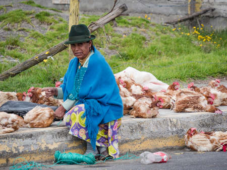 Saquisili, Ecuador - May 2, 2019 - indigenous lady selling in the Saquisili market in the Cotopaxi region of Ecuador, South Americaのeditorial素材