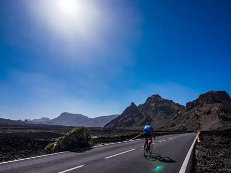 Tenerife, Spain - June 2 2019 - Cyclist biking around the volcanic landscape of Teide National Park in Tenerife Canary Islands Spainのeditorial素材