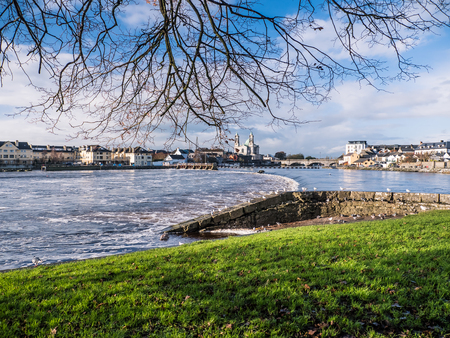 Seagulls over river in Athlone dam in background, irelandの写真素材