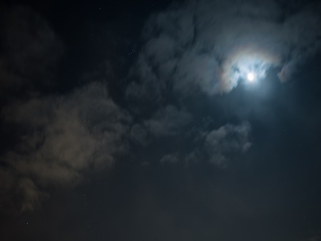 Night cloudy sky with stars and moonの写真素材