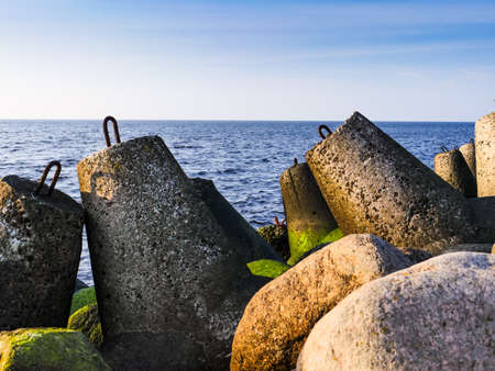 Daylight on the coast of the Riga Gulf at dawn with rocks in foregroundの写真素材