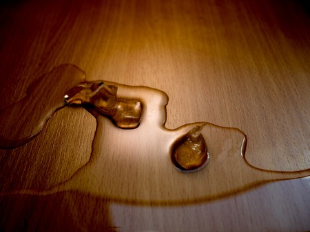 two ice cubes on brown wooden backgroundの写真素材