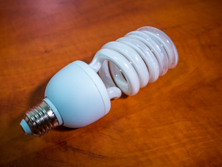 broken bulb light over brown background, shadow