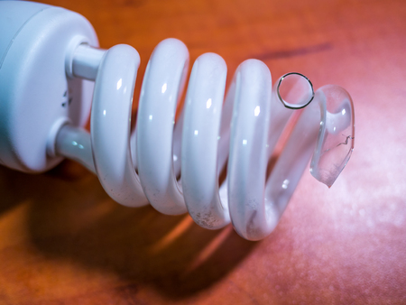 broken bulb light over brown background, shadowの写真素材