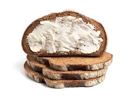 A slice of black rye bread spread with butter on a white background. Isolated object, a concept for...