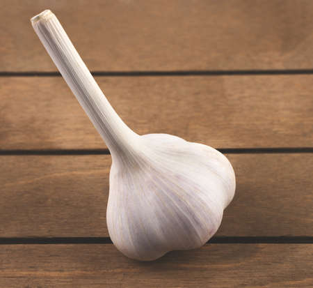 White garlic side view, placed on a wooden background. Plant background. The concept of food and agricultural products.の写真素材