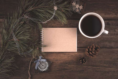 New year 2021, layout with Notepad, coffee Cup, pine branch and cones. Holiday background, top view and copy space. The concept of New year and Christmas.の写真素材
