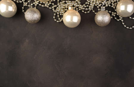 Happy new year 2021, Golden Christmas balloons and garland on a brown concrete background. Holiday background top view. The concept of the new year 2021 and Christmas.の写真素材