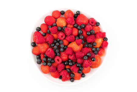 Fresh strawberries, raspberries, mountain ash in a plate on a light background. Berry background....
