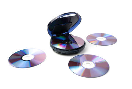 The CD player and old disks next to it are isolated on a white background. The concept of retro...