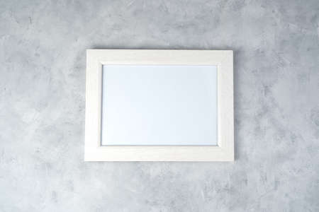 Minimalistic white frame with space for copying, on a concrete background. Concept of abstract...